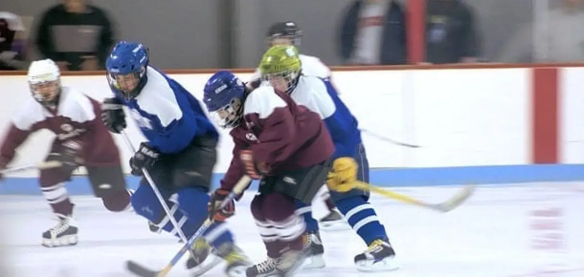 high school hockey team playing in rink, motion blurs