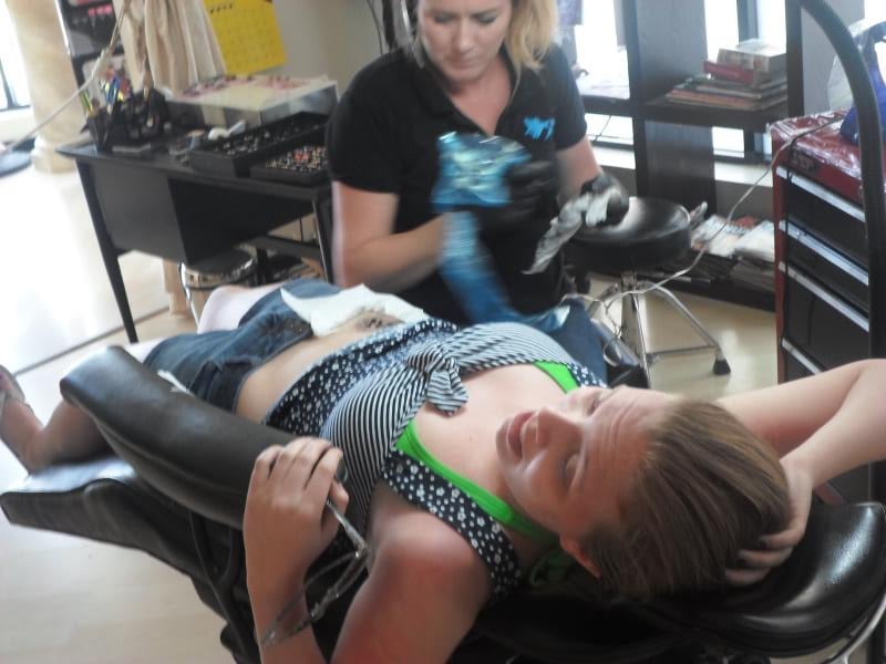 Kyra getting her tattoo.