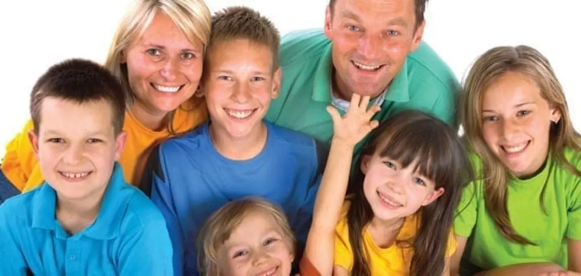 large blended family smiling together at camera