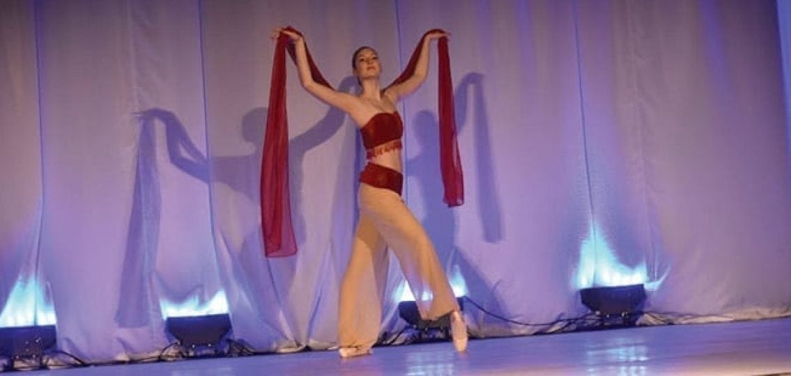 a teen performing ballet on a stage
