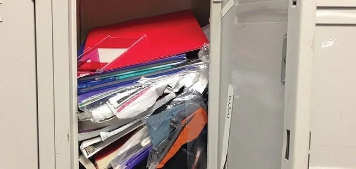 overstuffed messy locker with loose papers and folders