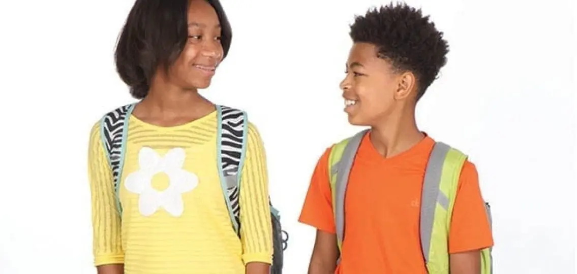 young middle school girl and boy smiling at each other