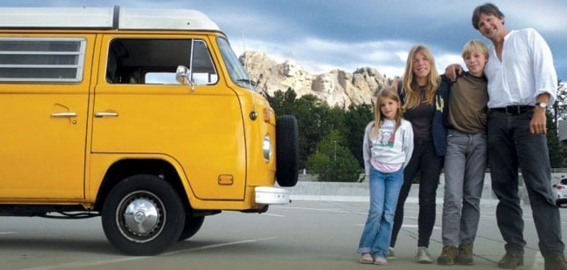 family road trip with a yellow RV by mt rushmore