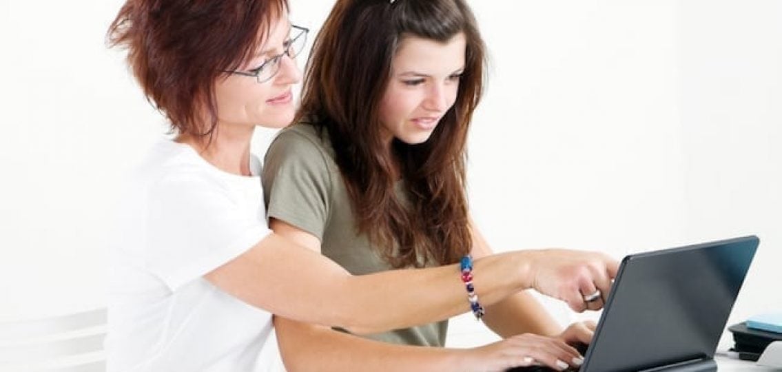 mom and teen looking at the computer