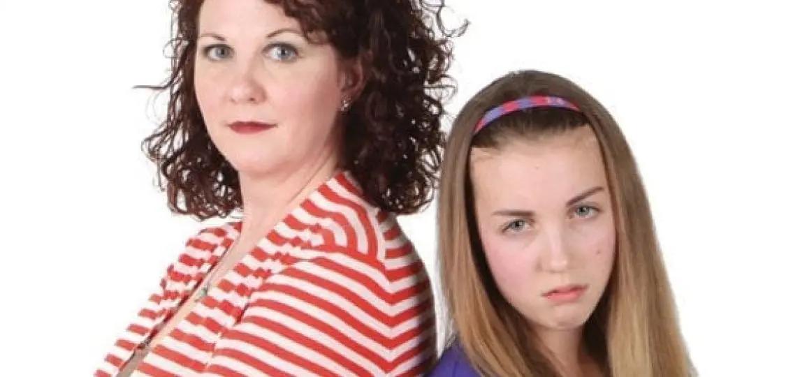 angry annoyed teenage girl back to back with mother