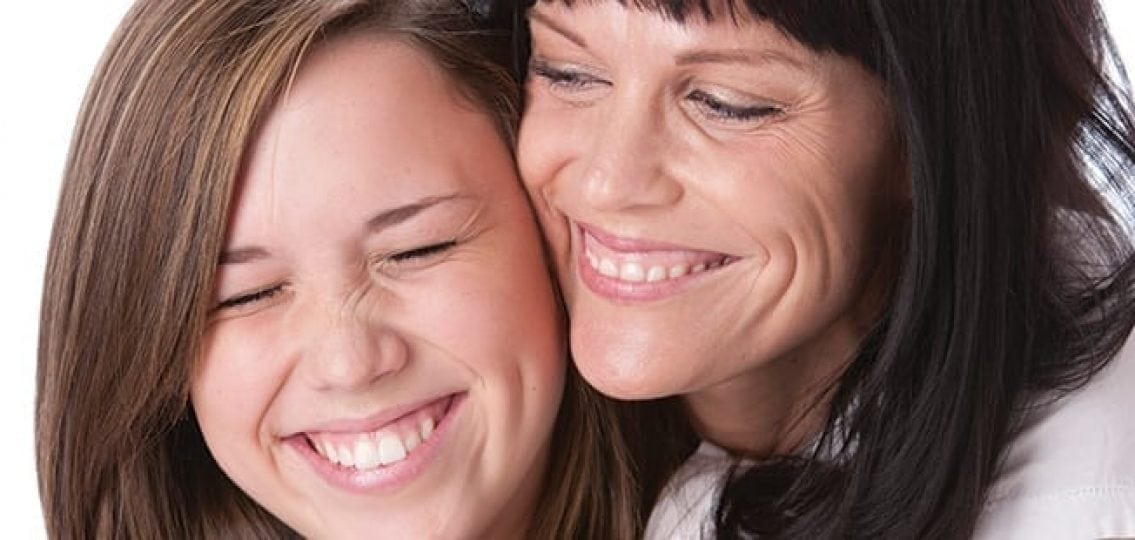 mom and daughter smiling and hugging