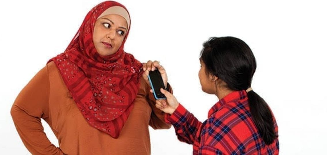 mom in hijab angrily taking phone from teen daughter