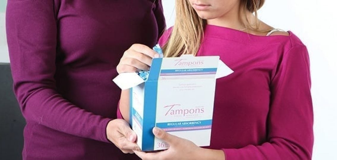 mother and daughter looking through a box of tampons
