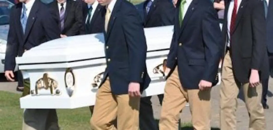 teen pallbearers carrying a white casket
