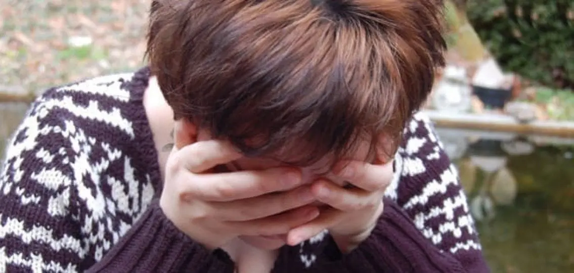 crying teenager at a memorial close up