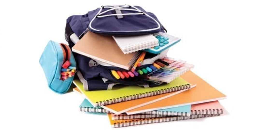 pile of school supplies backpack notebooks markers and pencils