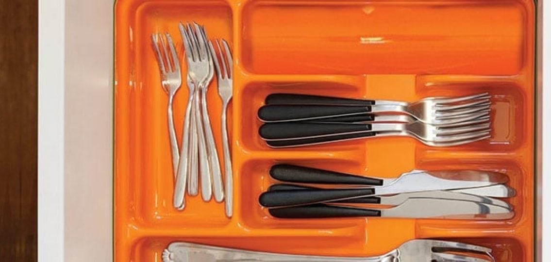orange silverware drawer with forks and knives organized