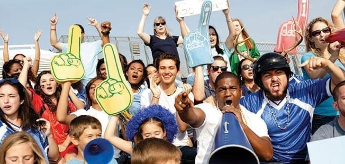 sports fans cheering at a high school game