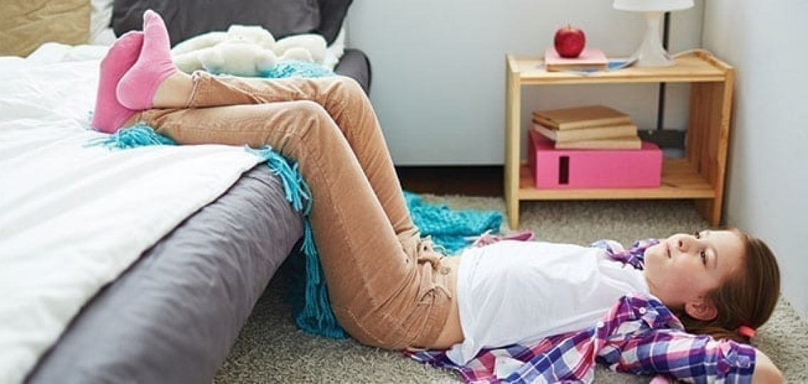 teen girl lying on her bedroom floor relaxing