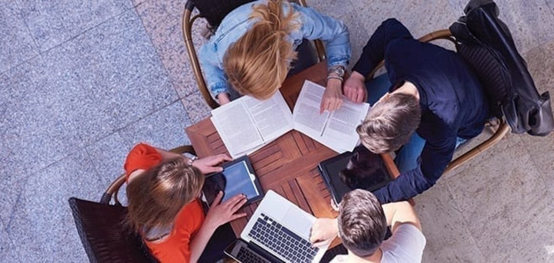 overhead teenage study group working on homework