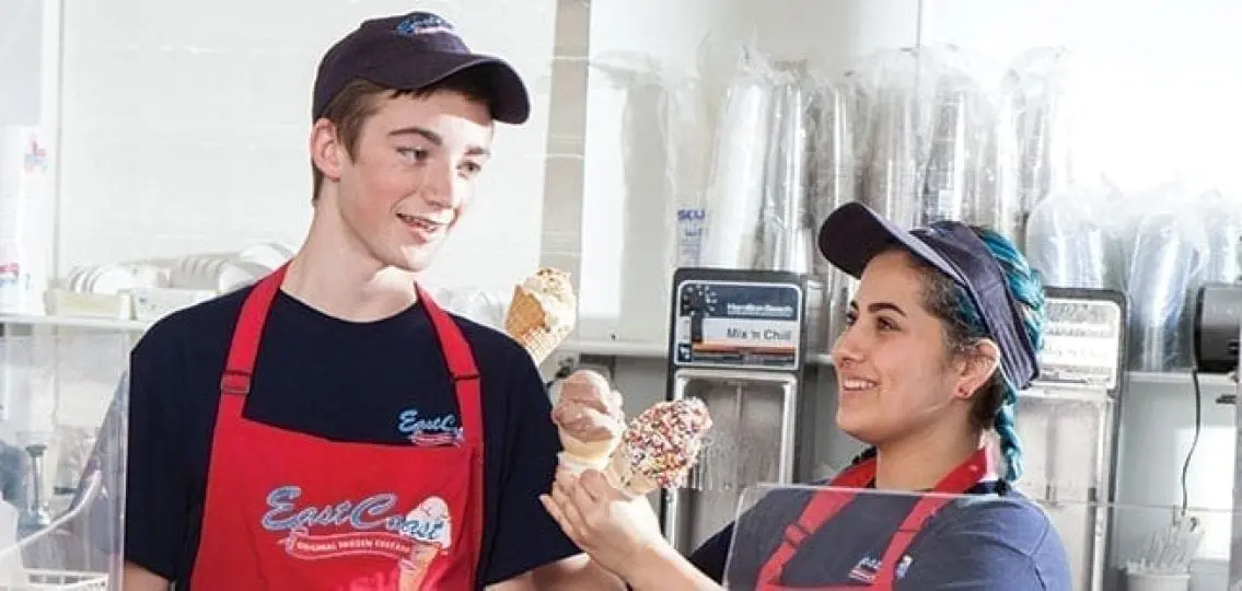 teenagers working a summer job at east coast custard holding ice cream
