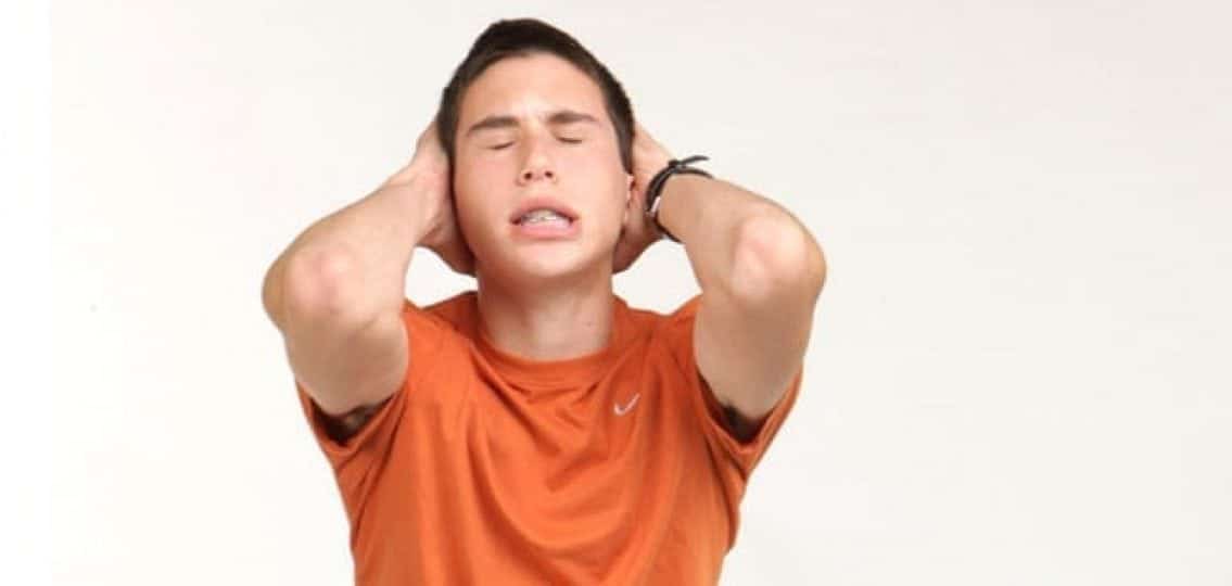 frustrated teen boy grabbing his head
