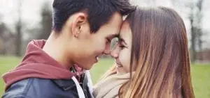 teen couple with their foreheads pressed together