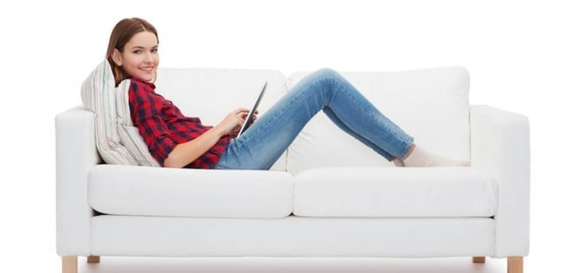 teenage girl on her tablet on the couch