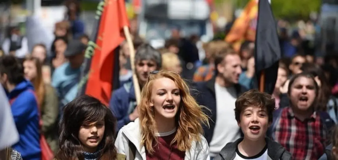 teens protesting at a large protest