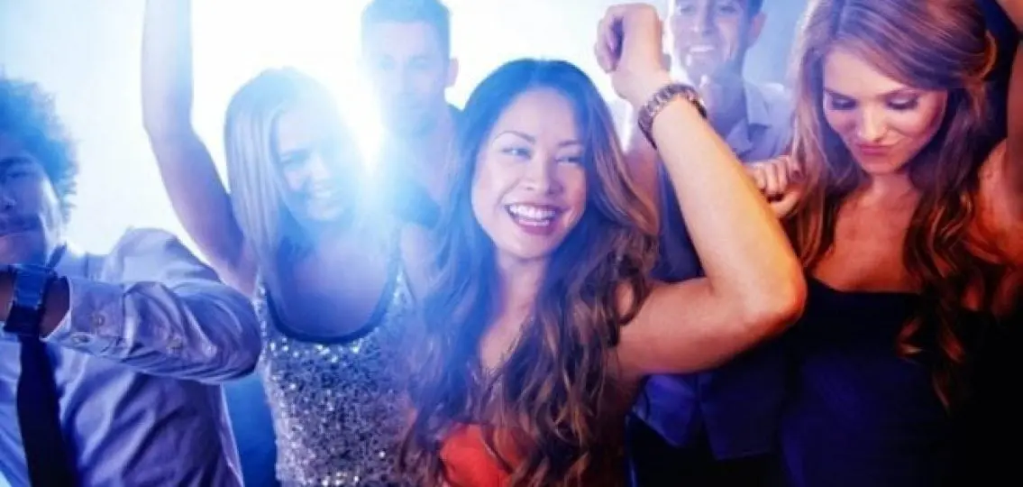 teenagers dancing at prom with bright light