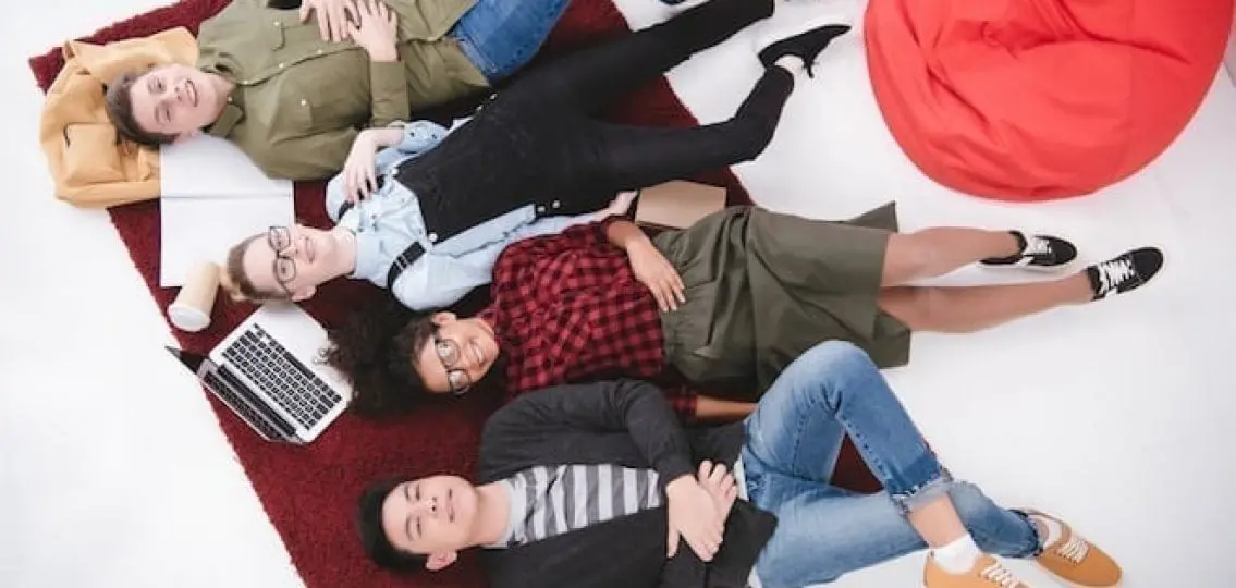 teens hanging out in basement lying on a rug