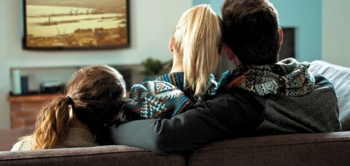 family looking for good shows to watch on tv on the couch together