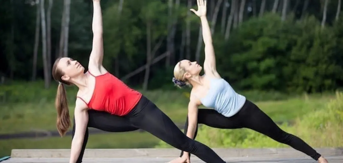 women doing outdoor yoga together