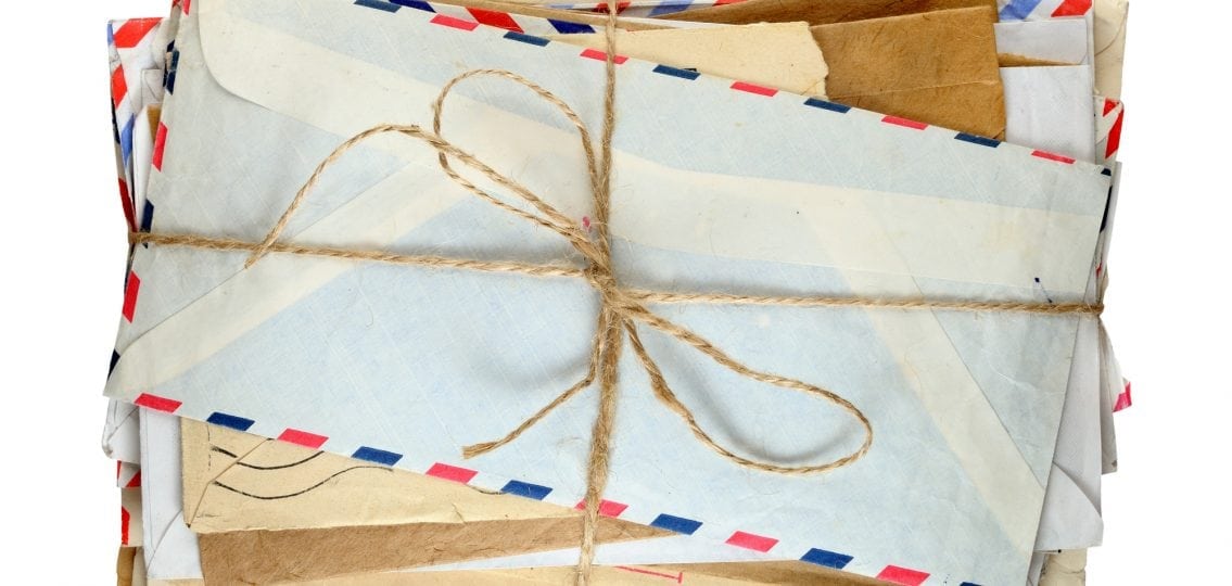a pile of letters from camp tied with brown string