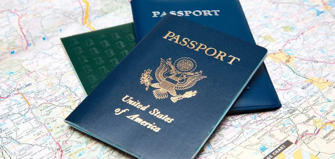 three passports of different styles on a paper map