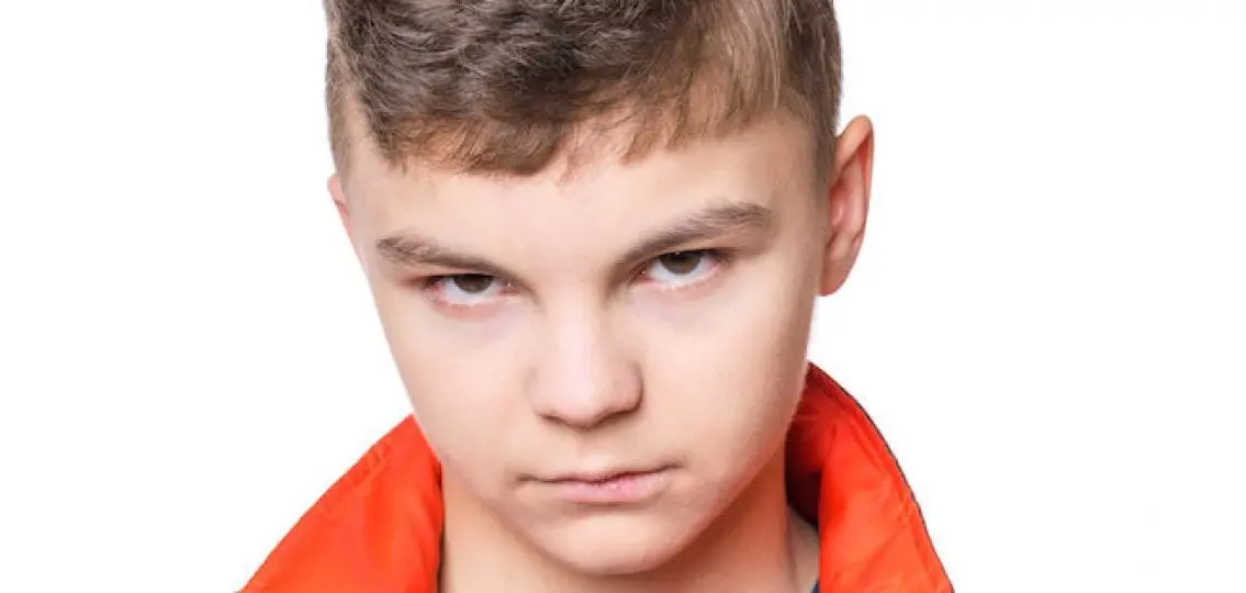 angry teen boy glaring at the camera