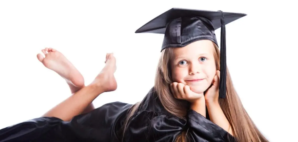 little girl in a graduation cap and robes