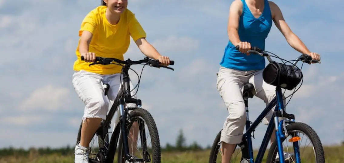 mom and teen on a bike ride on a sunny day together