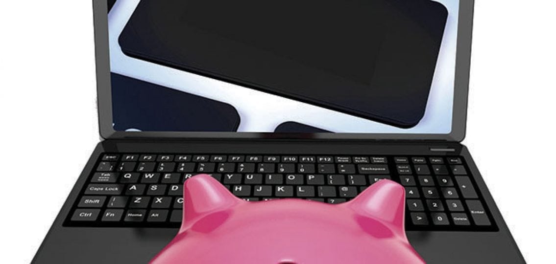 a piggybank at a laptop