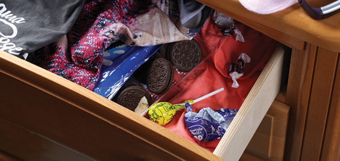 a clothes drawer with hidden snacks and candy
