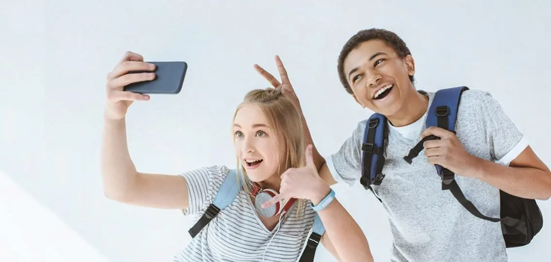 middle school friends taking selfie and posing
