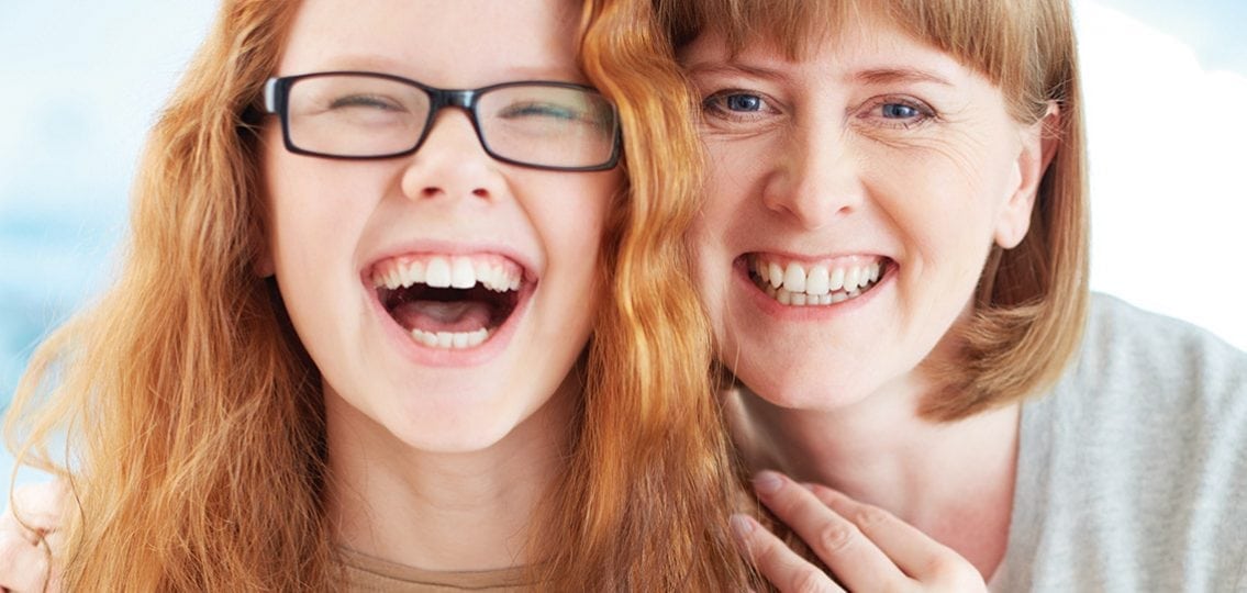 Lovely girl and her mother laughing together