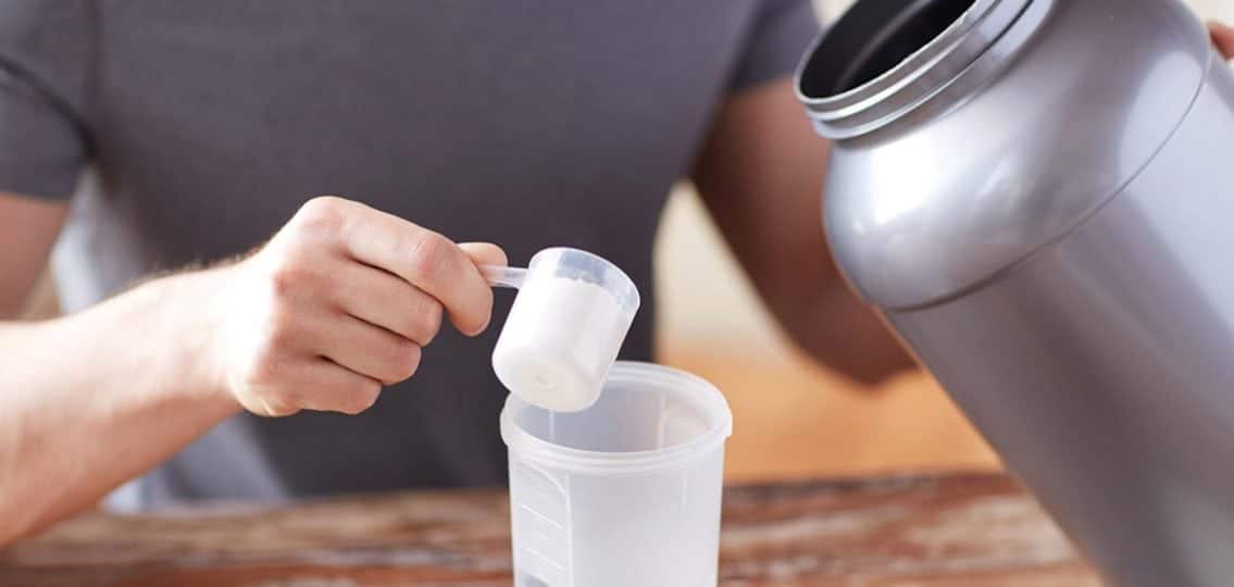 Close Up Of Man With Protein Shake Bottle And Jar