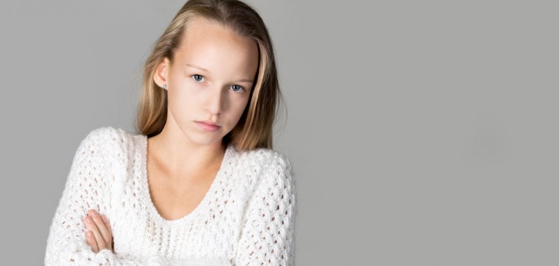 Girl With Sad Face annoyed stressed teen girl crossing her arms and glaring at the camera