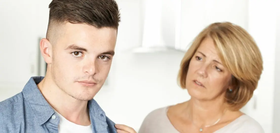 mom trying to talk to teen son who is pulling away going through puberty