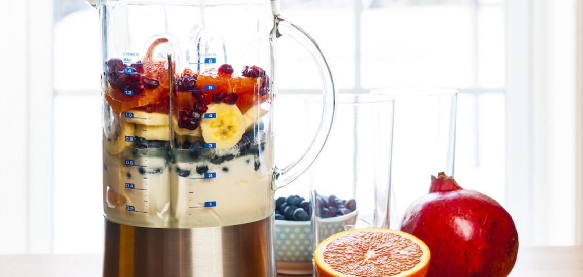 healthy smoothie with fruit and yogurt being prepared in a blender
