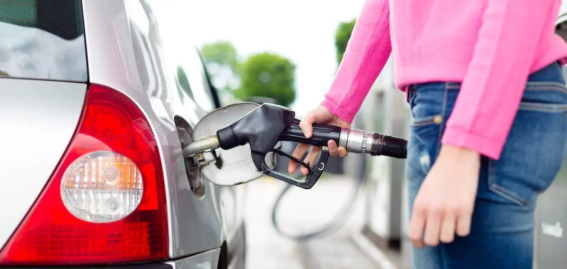 Lady Pumping Gasoline Fuel In Car At Gas Station.