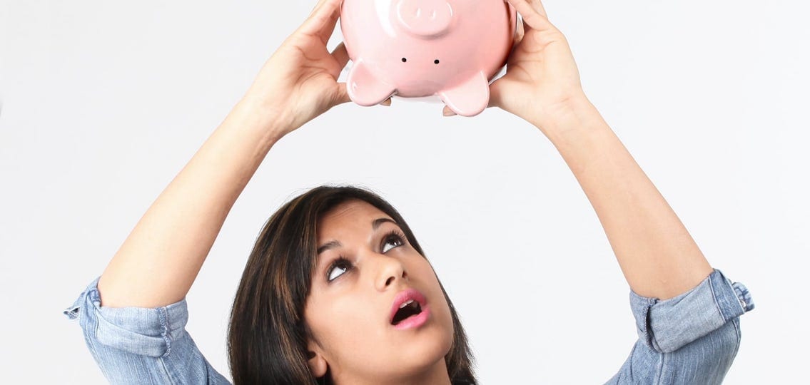 Girl With Bank holding upside down trying to get out money