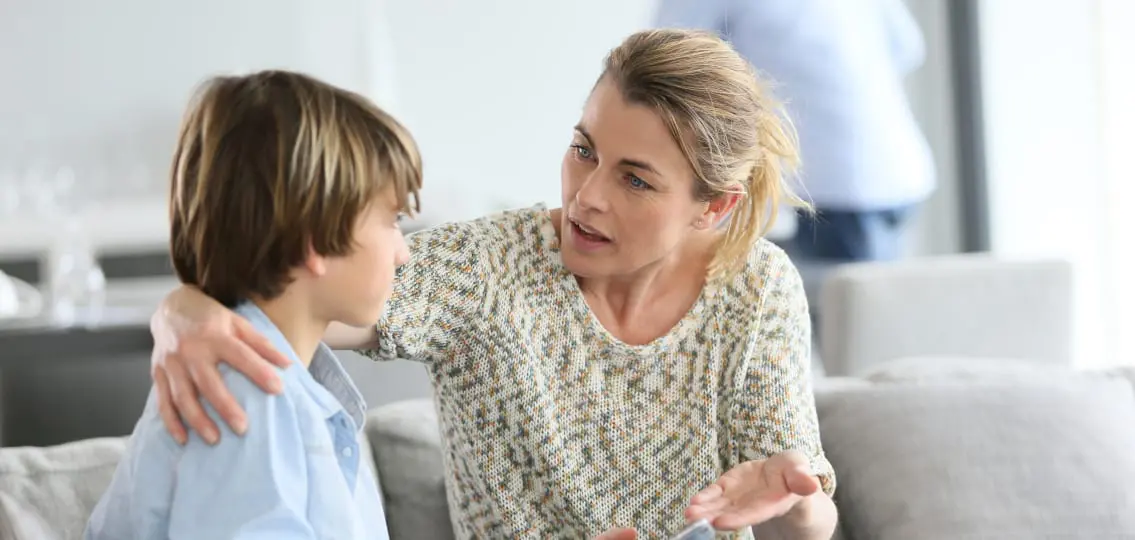 Mother Giving life advice To Young teen Boy Using Smartphone