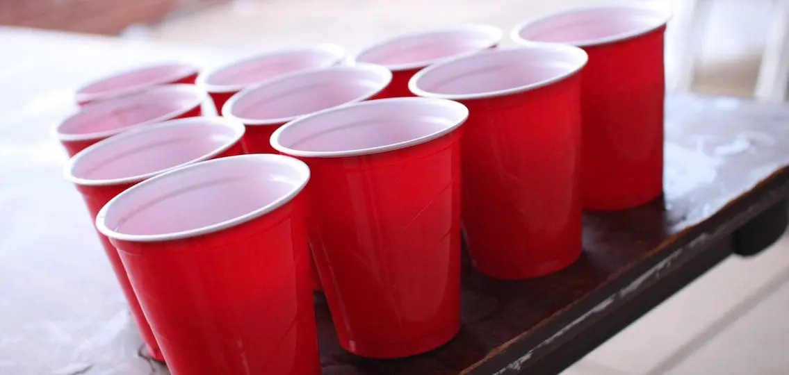 Red Solo Cups set up for beer pong on a table