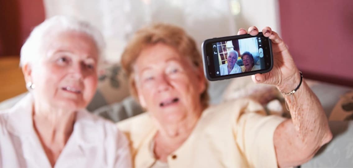 grandparents taking selfies together on a smartphone