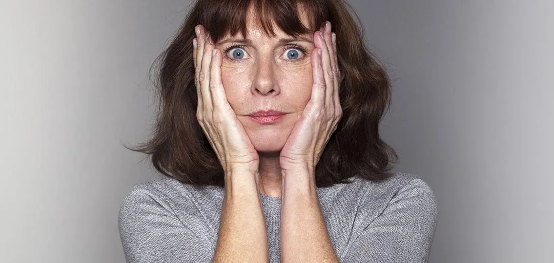 Anxious stressed Senior Woman Under Shock hands on her cheeks