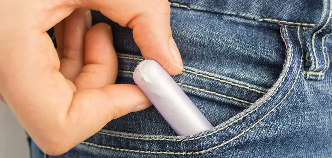 cropped shot of a woman s pocket taking tampon