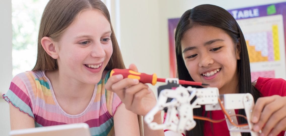 Two Female Pupils In Science Lesson Studying Robotics