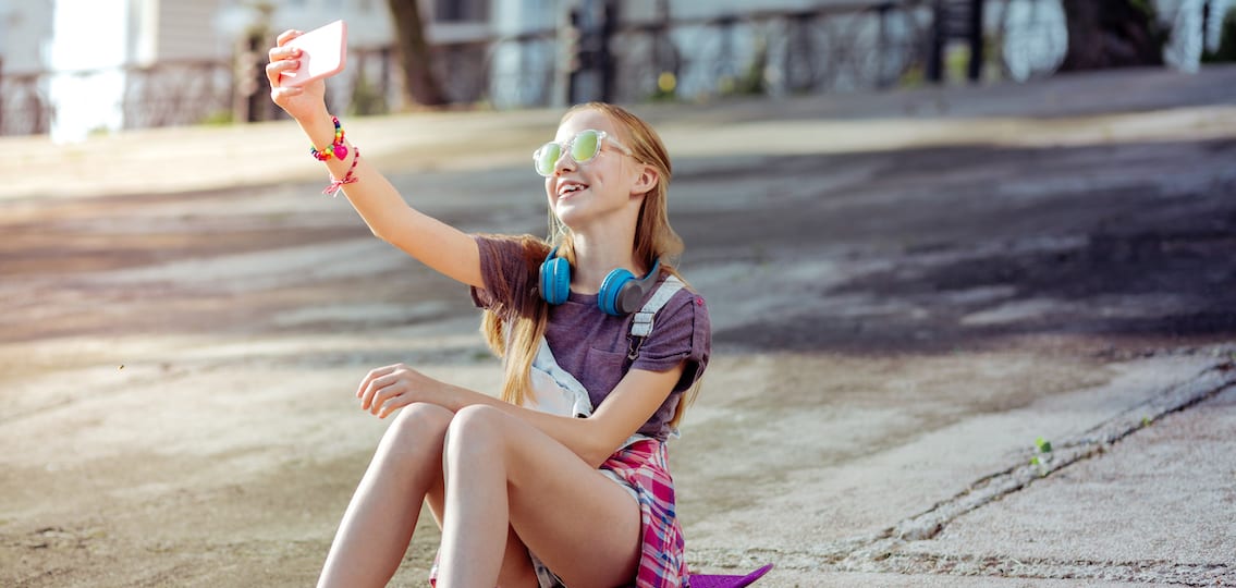 Young teen girl taking selfie